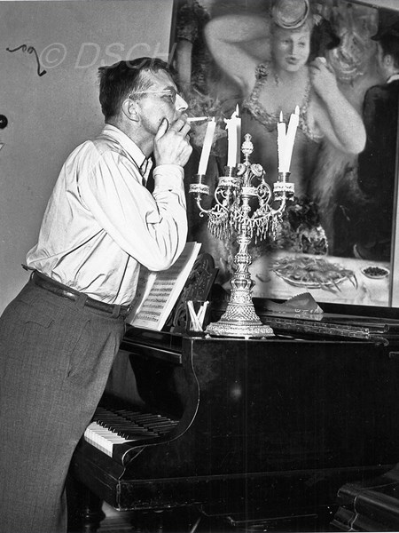 <p>In his office in front of a painting by Peter Will…</p>